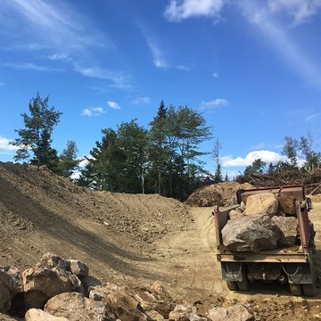 Truck moving rock and earth from site