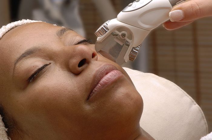 Woman getting skin brightening services on her face