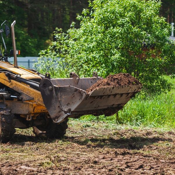 bulldozer scooping up dirt