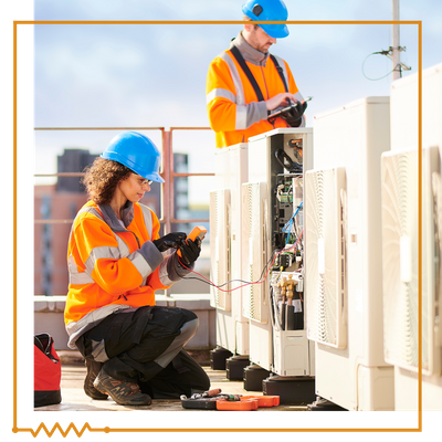 electricians fixing AC units on commercial roof