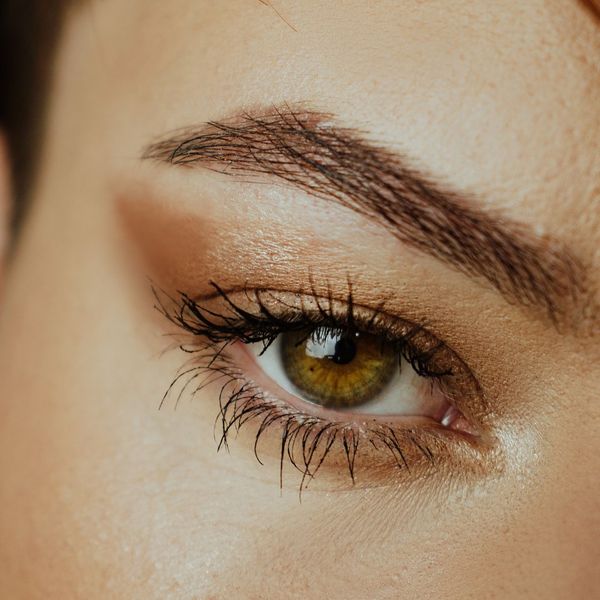 tidy tinted eyebrow in dramatic lighting, eye makeup