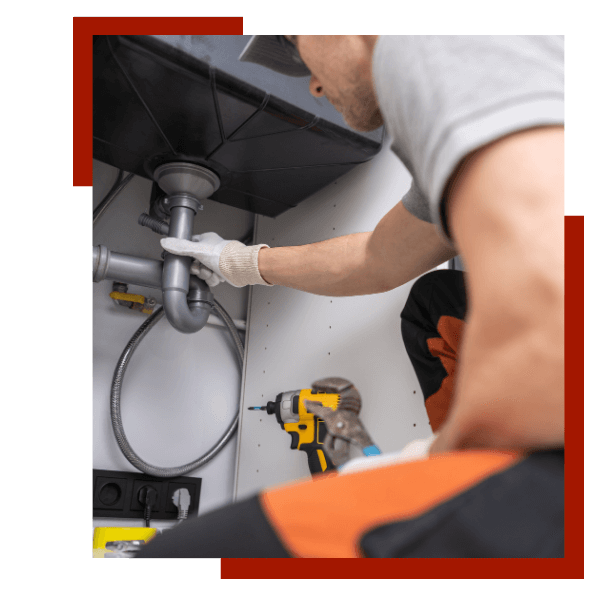 plumber working under a sink