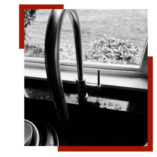 black and white photo of a kitchen faucet