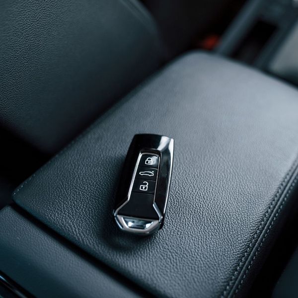 a key fob sitting on a car middle counsel 