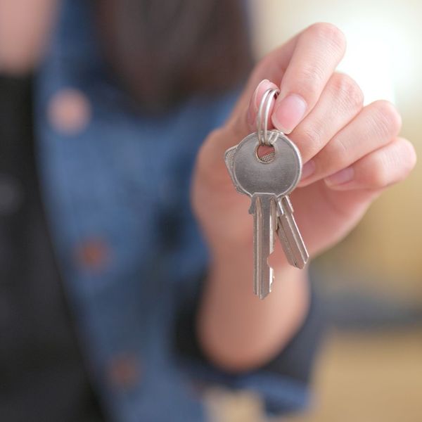A person holding spare keys out