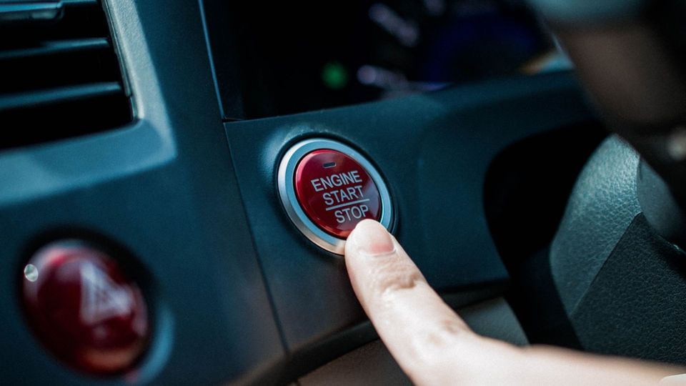 Pushing push to start button in car