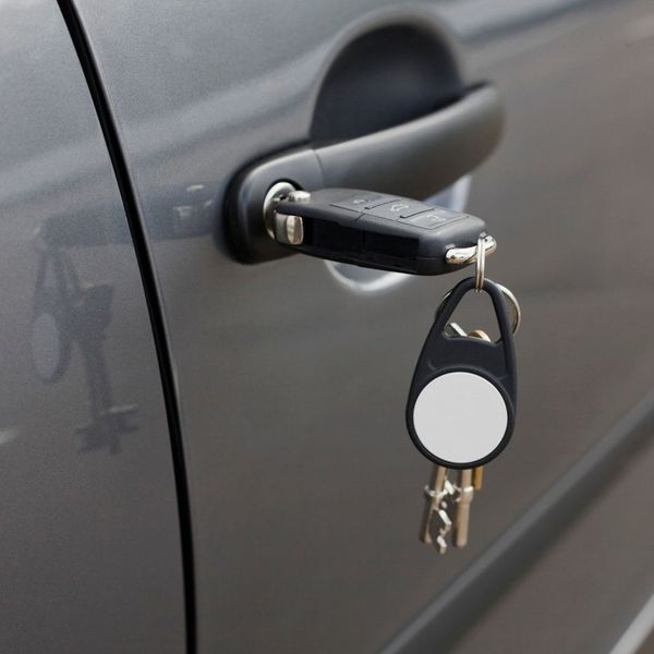 Key with fob hanging from vehicle door