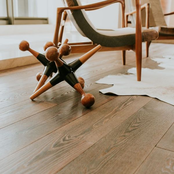 a modern room with traditional wood floors and nice furnishings