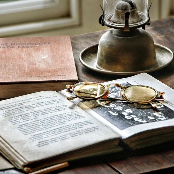 old book, glasses, and lantern