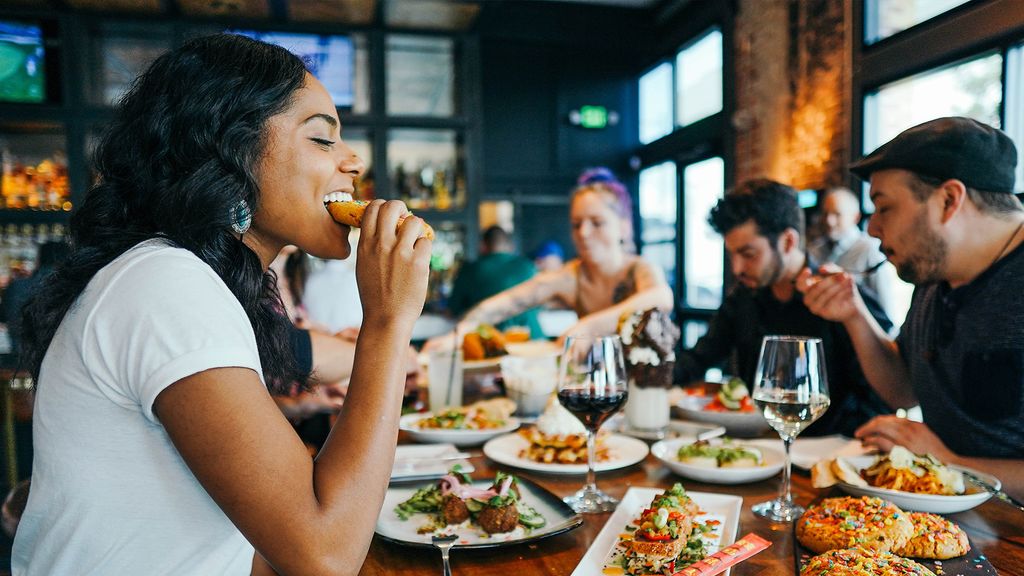 A woman enjoying her food at a restaurant