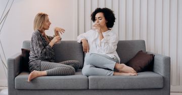 women sitting on a couch talking