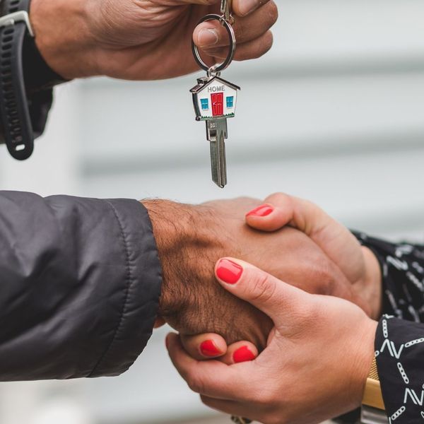 person holding a house key person holding a house key