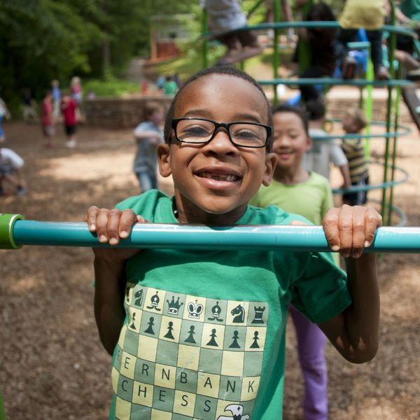 A happy boy playing at a park