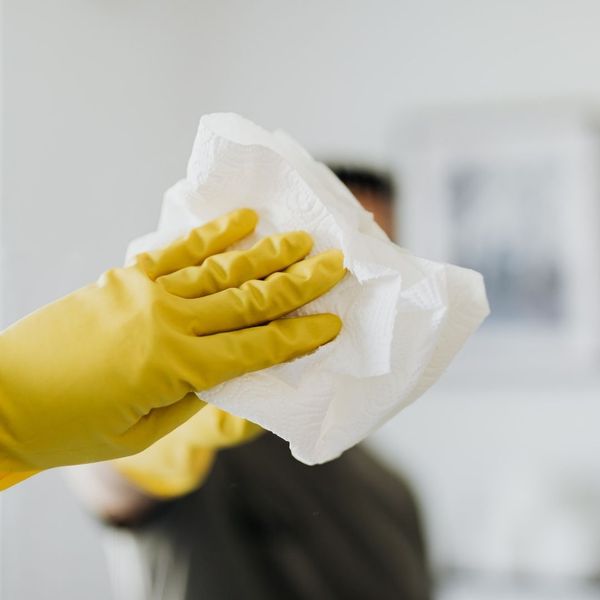 hand cleaning a mirror