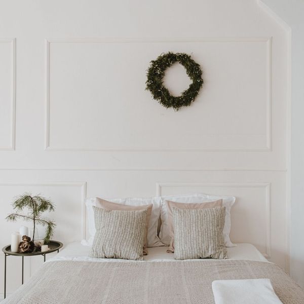 A tidy bed with throw pillows