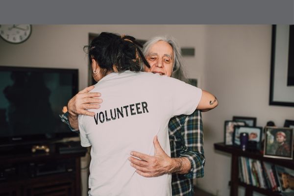 volunteer hugging someone