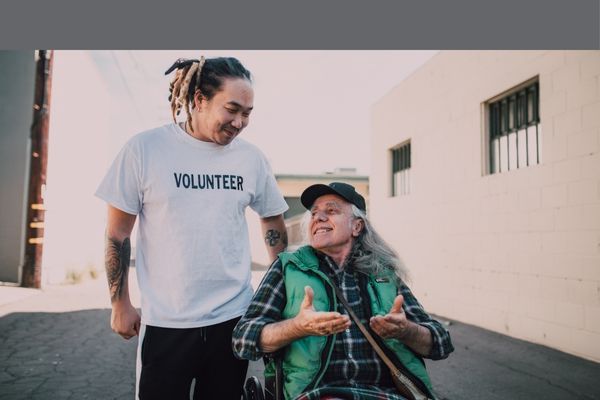 volunteer with man in wheelchair