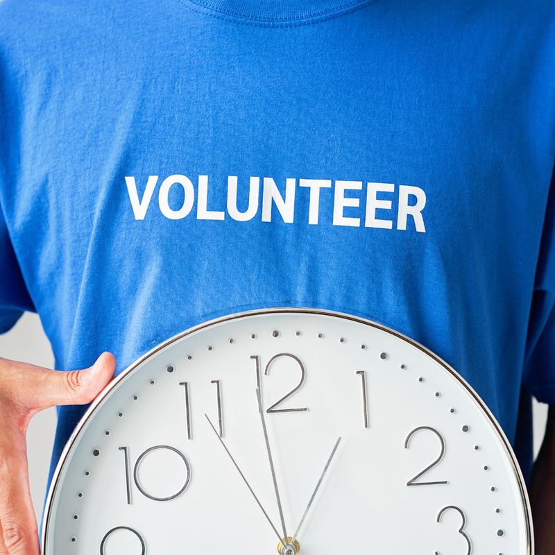 volunteer holding clock