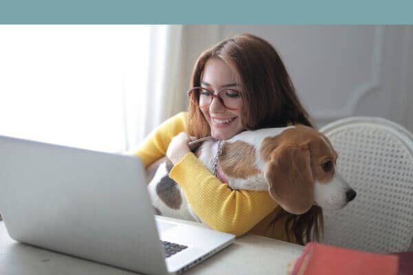 woman with dog on computer