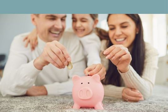 family puting money in a piggy bank