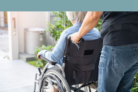 woman being pushed in wheel chair
