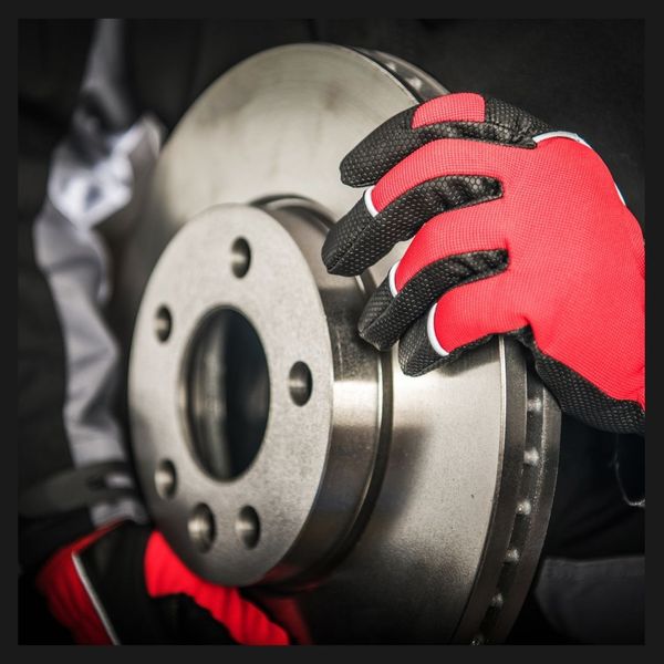 A mechanic changing the brakes of a car