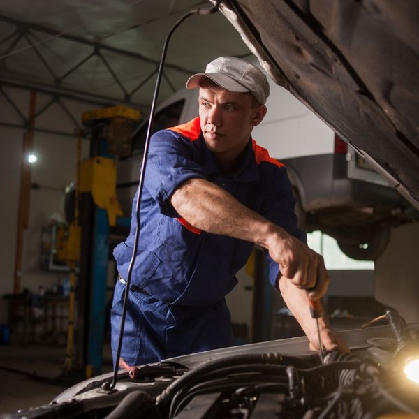 Mechanic under the hood of a car