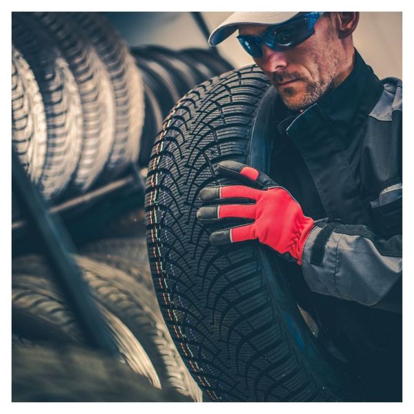 technician carrying tire