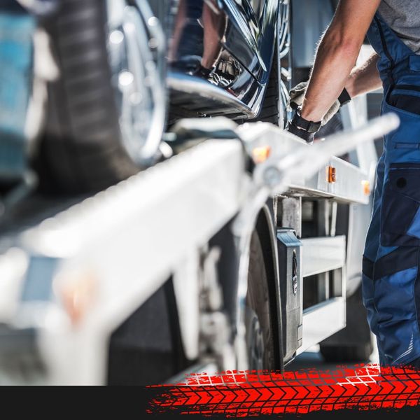 car being tied down on a tow truck