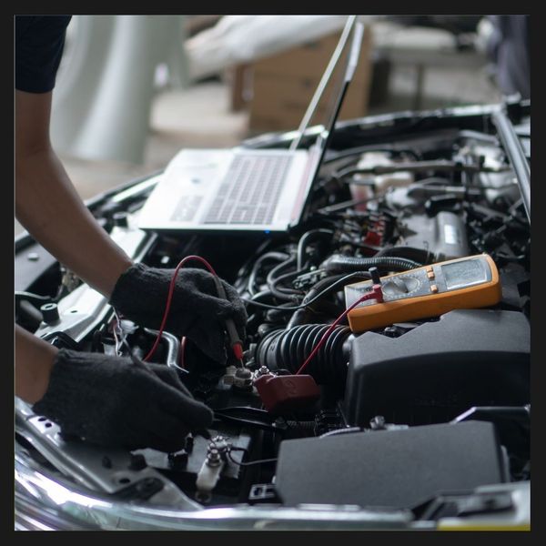 A mechanic diagnosing an engine 