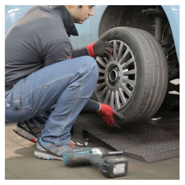 A mechanic switching a tire