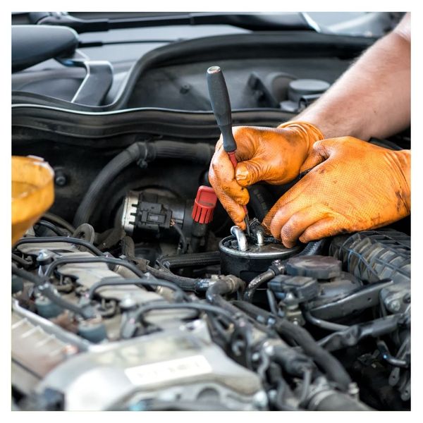 A mechanic working on a car