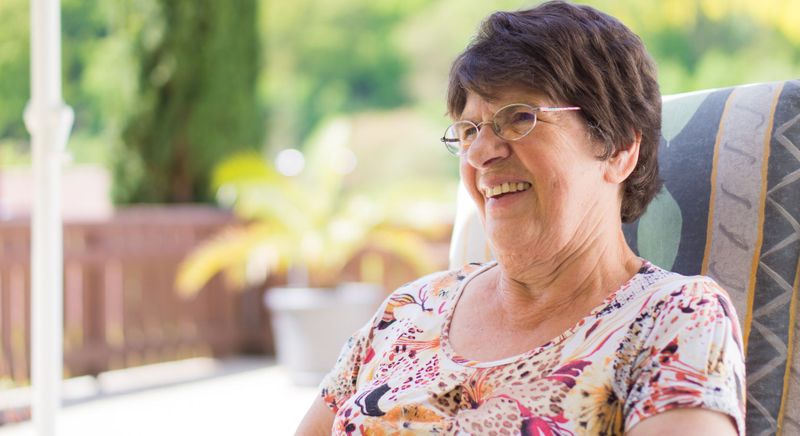 older woman sitting in chair