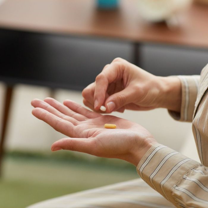 person taking supplements