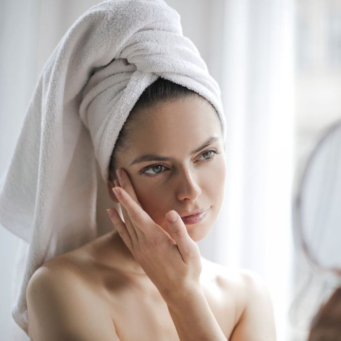 woman touching her face