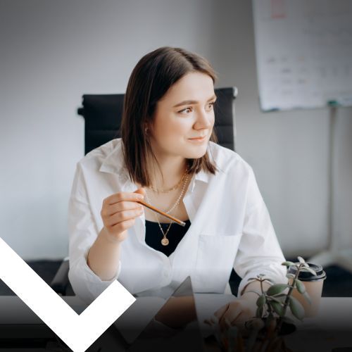 Woman in White Top Sitting at the Table