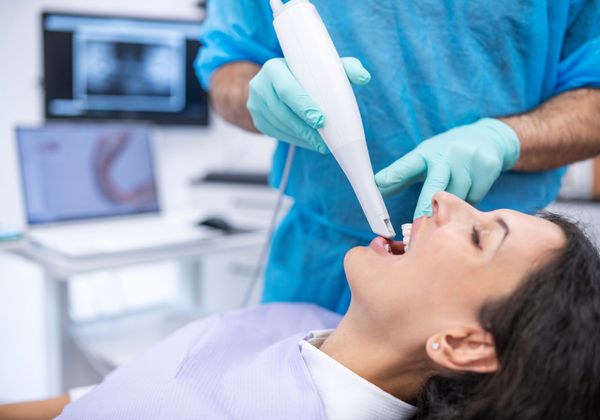 dentist using intraoral scanner on patient