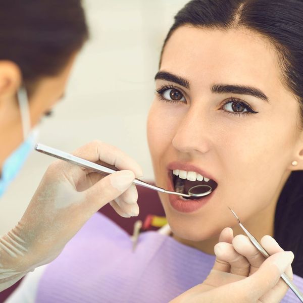 examining young girl's teeth