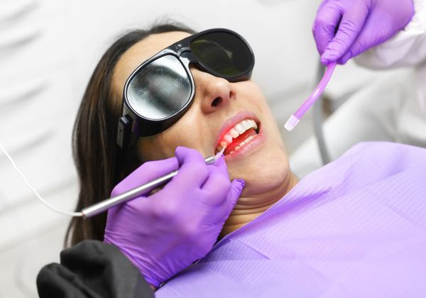 woman getting dental laser treatment