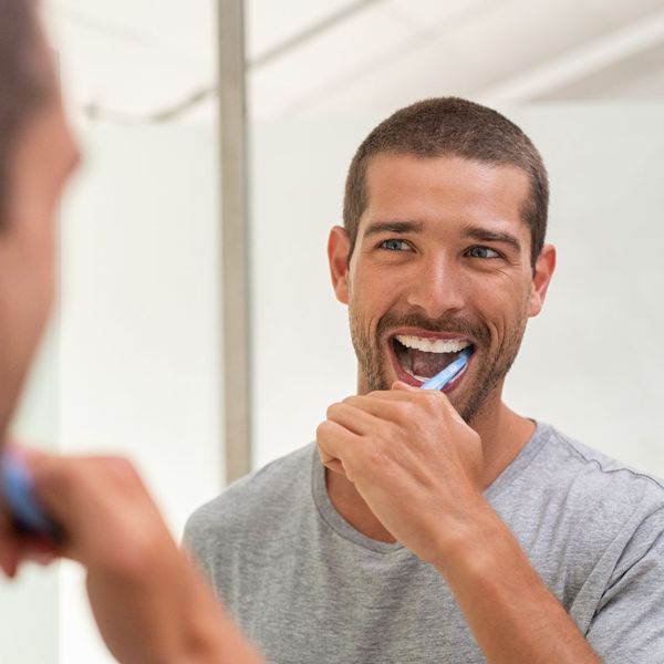 man brushing teeth