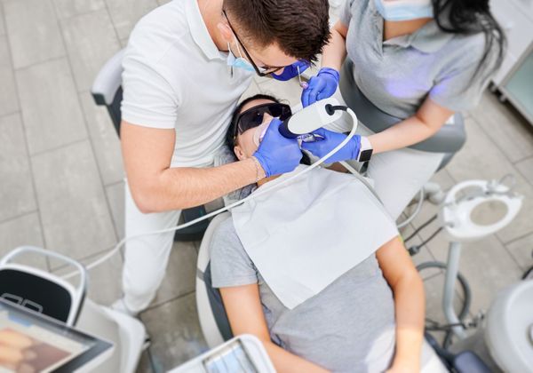 dentist taking an intraoral scan of patients teeth