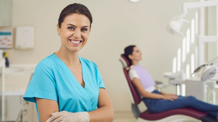 orthodontist nurse with patient in background