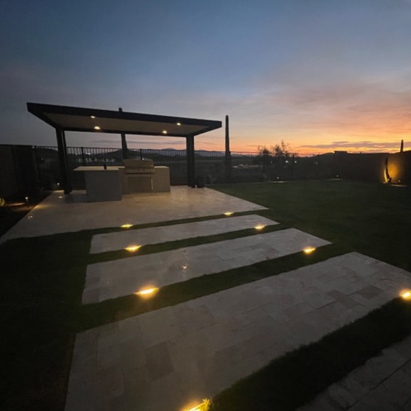 outdoor pergola with lighting, hardscape, turf and outdoor kitchen
