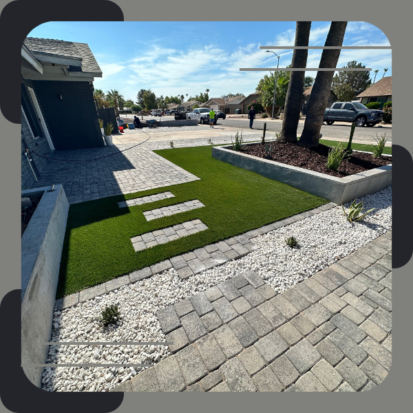 Modern landscaping with stepping stones and artificial turf.