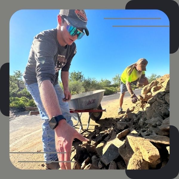 Workers handling rocks for landscaping projects.