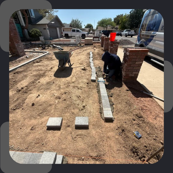 professional hardscaper installing paver border