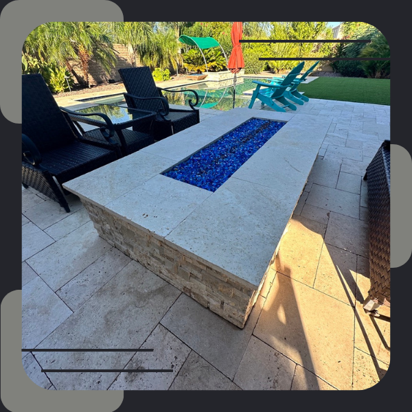 travertine hardscape with built in fireplace