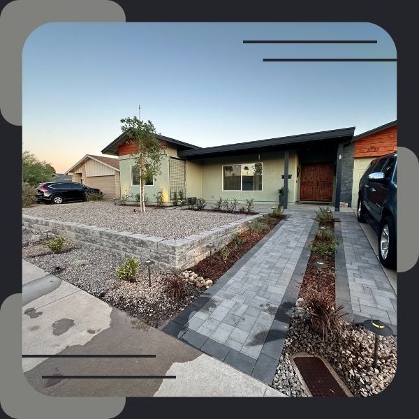 Finished front yard with modern hardscape and plants.