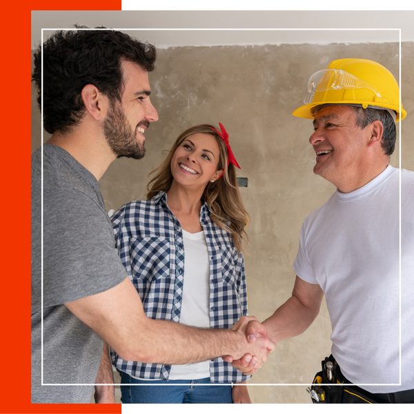 contractor shaking hands with a couple. 