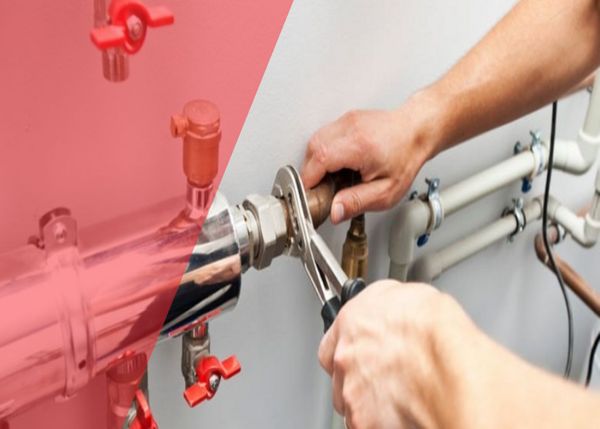 Plumber working on pipes